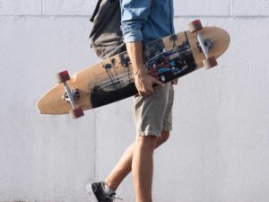 man walking with skateboard on hand