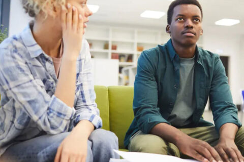 man looking front and women staring at man